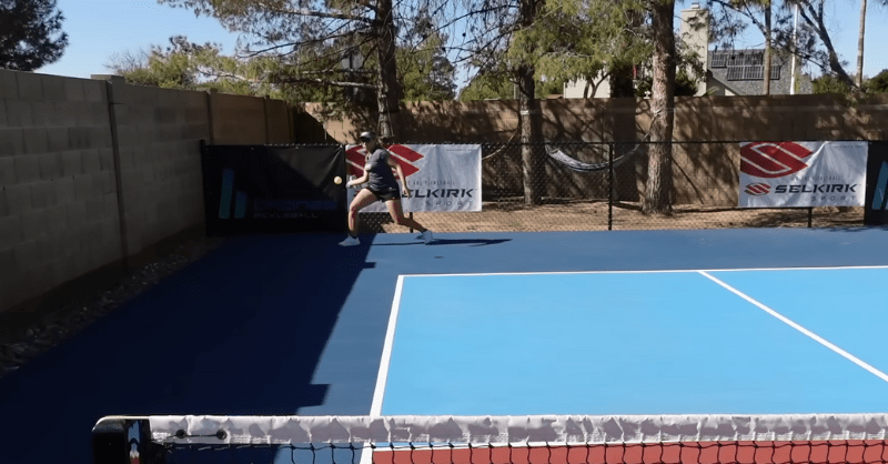 a pickleball player shooting from the right corner